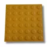 Taktilis útburkolati figyelmeztető elem vakok és gyengénlátók részére, sárga PVC-ből, 300x300x2,2 mm-es lap. M01 pont